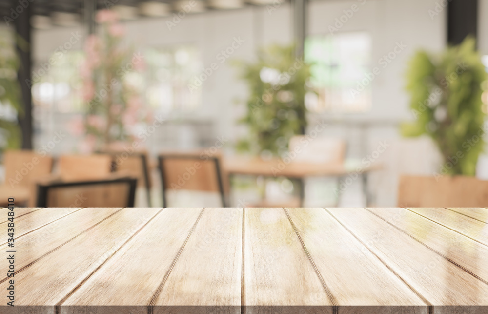 Empty of wood table top with blurred coffee shop on background Empty of wood table top with blurred coffee shop on background