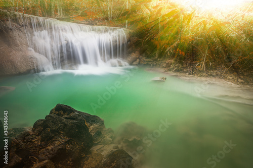 Waterfall in autumn forest with light ray  tyndall lighting effect  Huay Mae Kamin Waterfall   Beautiful waterfall in rainforest at Kanchanaburi province  Thailand