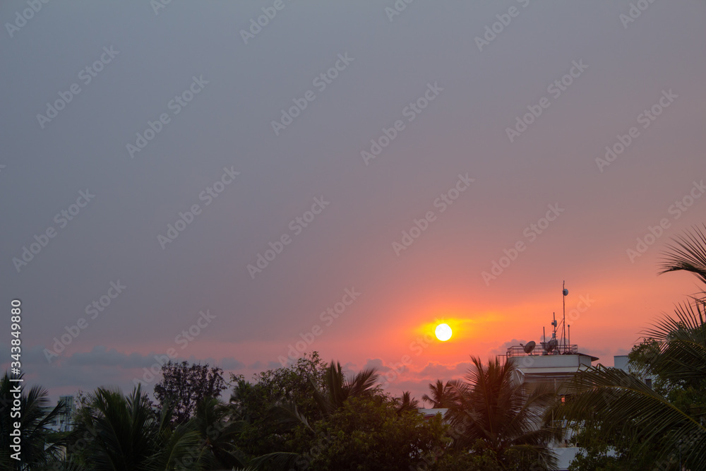 Beautiful view of the sunset in cityscape. Sunset view from city bulding terrace