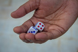 Adult holding the dices and ready to roll. Rolling out the dices