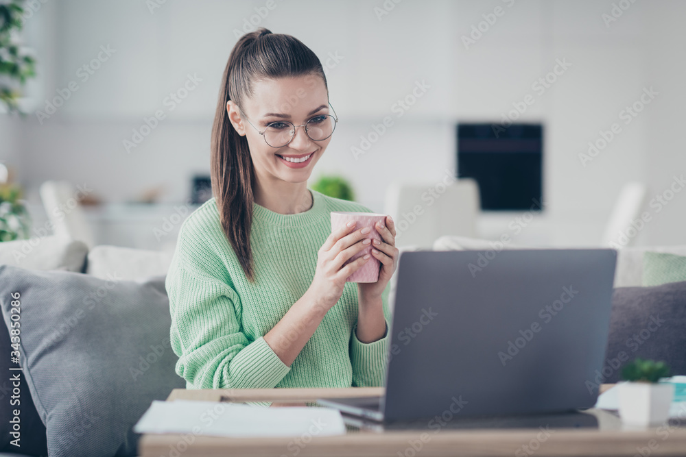 Close-up portrait of her she nice attractive lovely pretty cheerful cheery smart clever brunet girl working on laptop analyzing data drinking hot cacao at light white interior room studio flat Close-up portrait of her she nice attractive lovely pretty cheerful cheery smart clever brunet girl working on laptop analyzing data drinking hot cacao at light white interior room studio flat