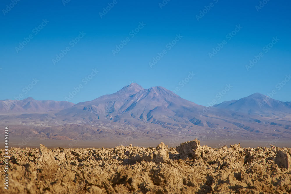 Eroded soil and view of the landscape at Chaxa Lagoon & Flamingos National Reserve Conaf. an Pedro de Atacama, Antofagasta - Chile. Desert. Andes Range.