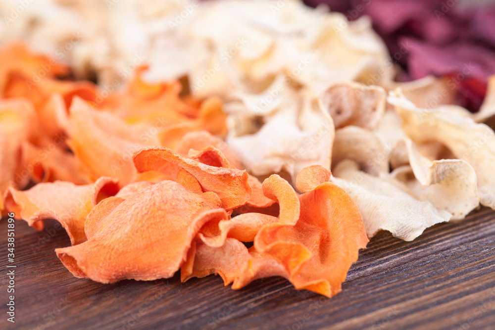 Set of chips from vegetables and fruits in craft bowls. Dried vegetables and fruits. An organic snack for the whole family. Healthy eating concept. Close up photo, selected focus Set of chips from vegetables and fruits in craft bowls. Dried vegetables and fruits. An organic snack for the whole family. Healthy eating concept. Close up photo, selected focus
