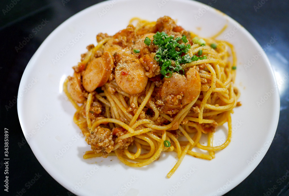Spaghetti with sausage and tomato cream sauce seasoning with onion leaf Spaghetti with sausage and tomato cream sauce seasoning with onion leaf