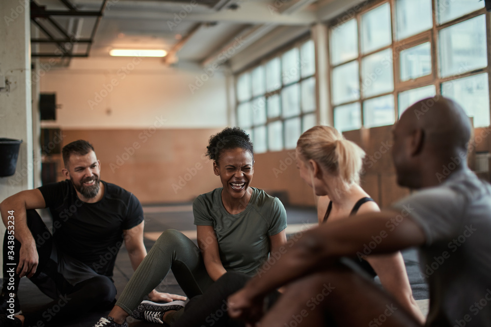 Fit group of diverse friends laughing together at the gym Fit group of diverse friends laughing together at the gym