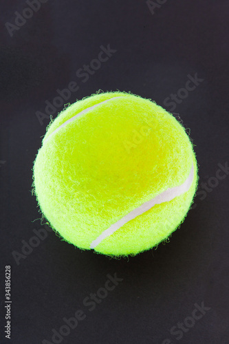A tennis ball on the black background © azyryanov