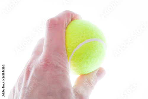 The tennis ball in the man's hand