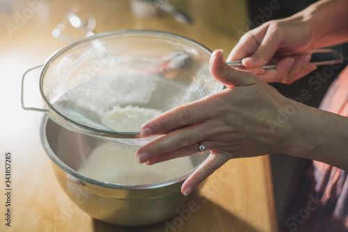 Flour being sifted into mixing bowl
