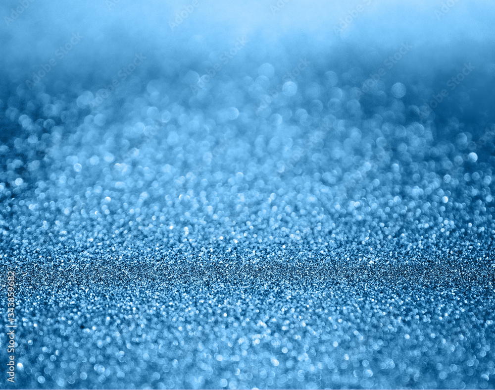 Obraz premium Classic blue abstract background with shiny glitter. Blue festive sparkling macro texture. Holiday backdrop with copy space.