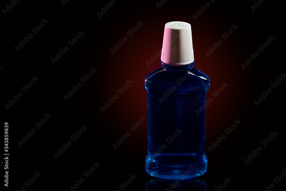 blue liquid. mouthwash. black background blue liquid. mouthwash. black background