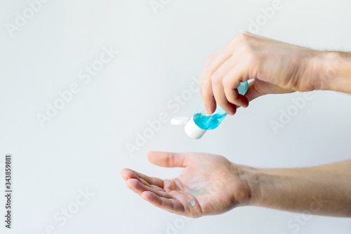 hands closeup. a person uses a sanitizer. hand disinfection. safety. social distance.