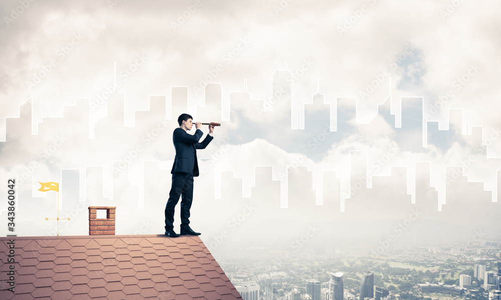 Engineer man standing on roof and looking in spyglass. Mixed med Engineer man standing on roof and looking in spyglass. Mixed med