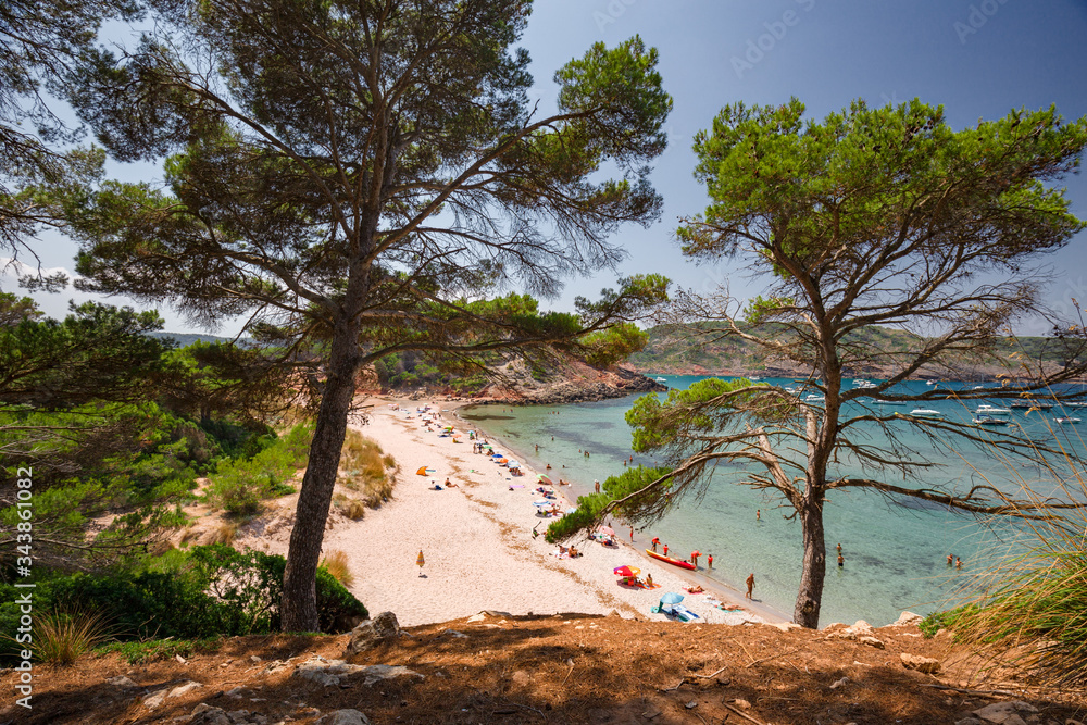Panoramic view of a beach full of bathers on the island of Menorca in Spain. Panoramic view of a beach full of bathers on the island of Menorca in Spain.
