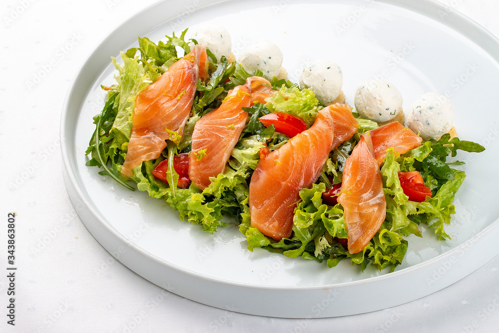 Salmon salad with cheese balls on a white plate Salmon salad with cheese balls on a white plate