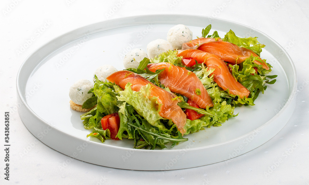 Salmon salad with cheese balls on a white plate Salmon salad with cheese balls on a white plate