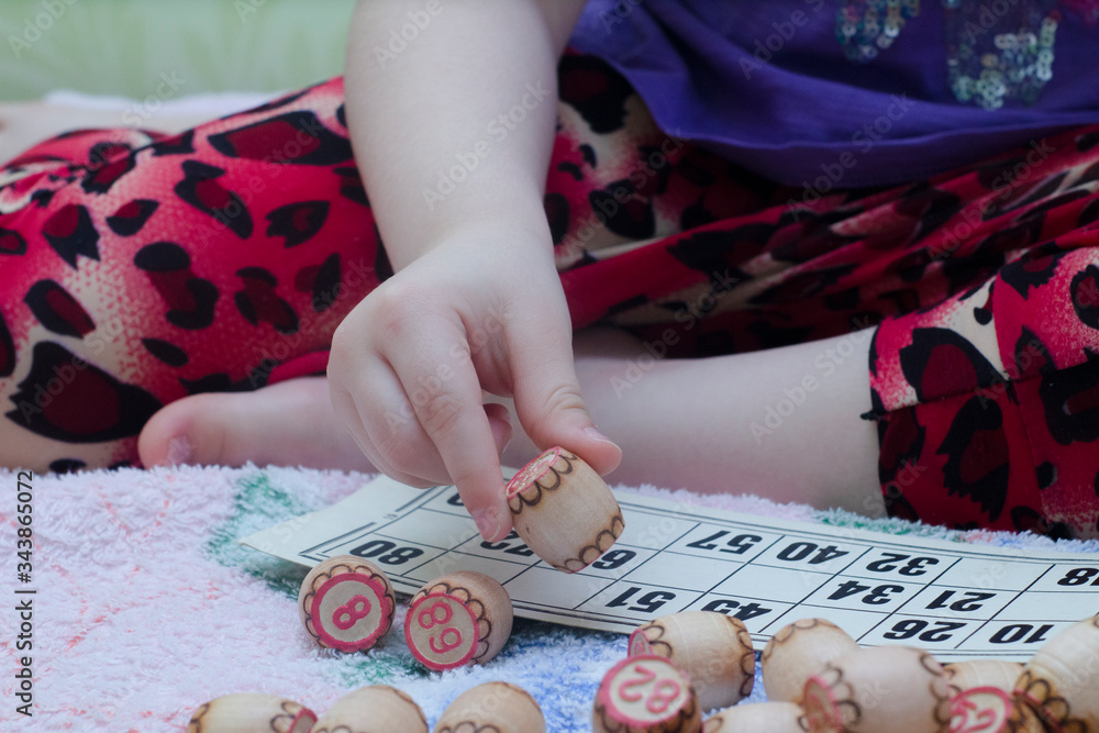 The child plays lotto. hold the barrels in your hands. board game during the weekend and insulation at home. The child plays lotto. hold the barrels in your hands. board game during the weekend and insulation at home.