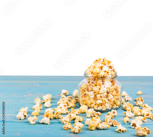 Delicious caramel popcorn on the table. Golden popcorn on white background. Homemade Popcorn in Jar. photo