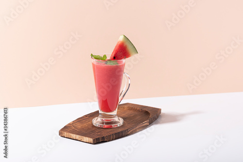 Fresh water melon juice and watermelon slice on color background. summer drink.