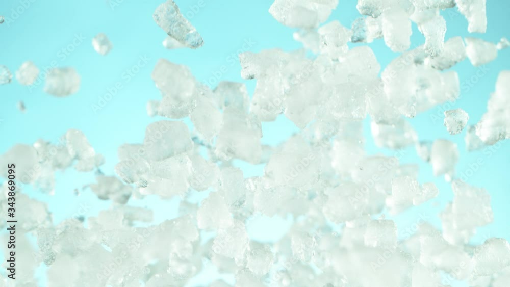 Super slow motion of falling crushed ice separated on blue background. Filmed on high speed cinema camera, 1000 fps. Super slow motion of falling crushed ice separated on blue background. Filmed on high speed cinema camera, 1000 fps.