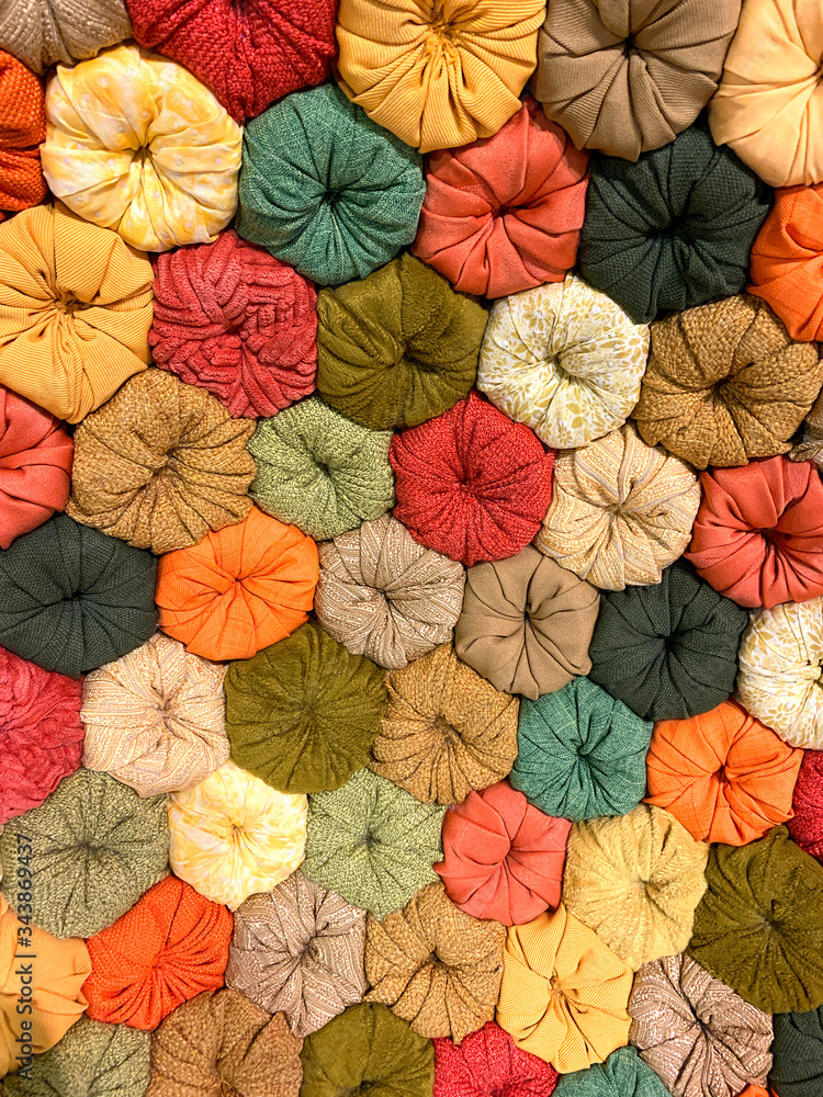 View of colorful, flower shaped fabric background. View of colorful, flower shaped fabric background.