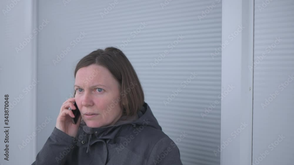 Casual woman using mobile phone for communication outdoors Casual woman using mobile phone for communication outdoors