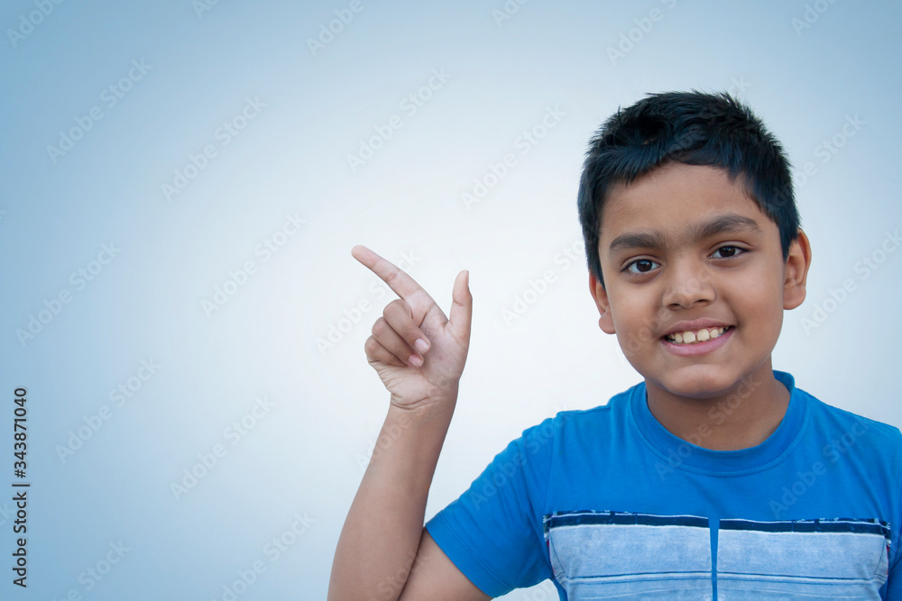 Happy boy pointing against Color background
Happy boy pointing against Color background