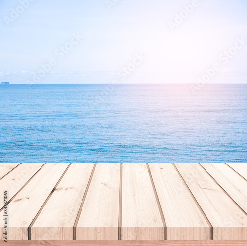 wood table or wood floor with blue sea scape background for product display