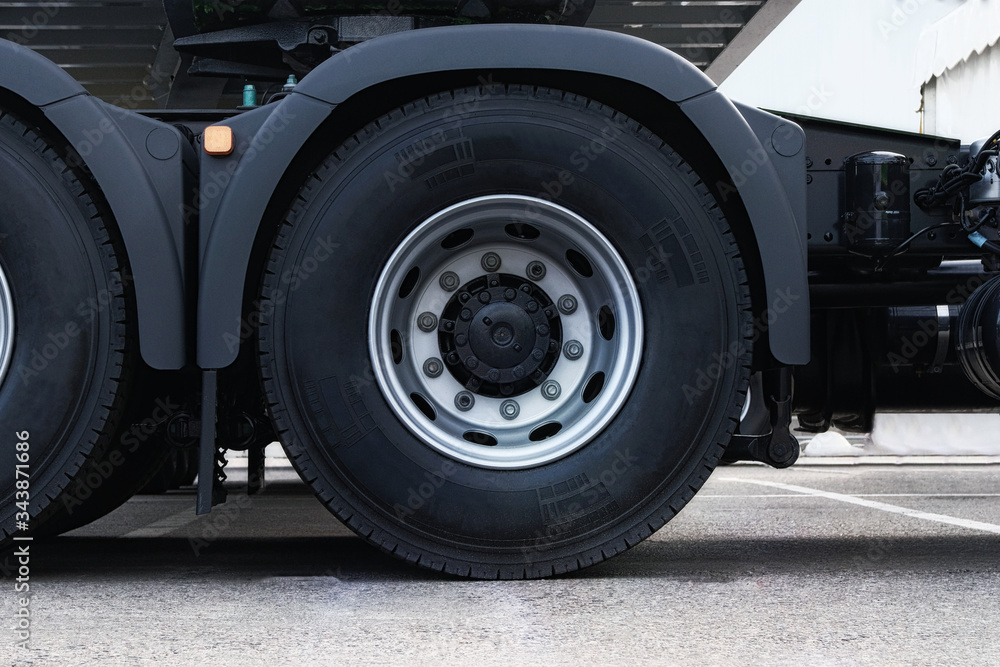 Truck tire, wheel of heavy duty semi truck, close up. Freight industry transport, wheels of modern truck.