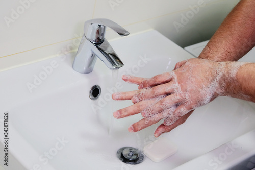 Hygiene and prevention of infection. Washing hands rubbing with soap man for corona virus prevention. Cleaning to stop spreading covid-19.