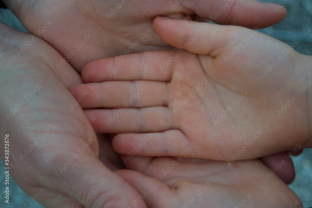 The palms of an adult and a child, mom and child. The palms of an adult and a child, mom and child.