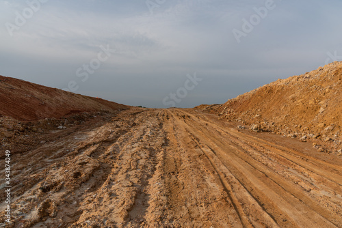 Wide dirt slope road landscape
