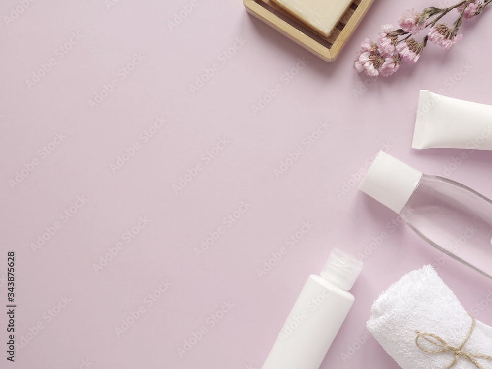 care products lotion, cream, plant, soap, towel. bath accessories on pink background, top view, copyspace. Bodycare beauty treatments at home concept, organic products, morning routine care products lotion, cream, plant, soap, towel. bath accessories on pink background, top view, copyspace. Bodycare beauty treatments at home concept, organic products, morning routine