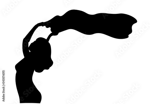 A silhouette of a beautiful woman who holds a flag above her head. Fight for women's rights concept.