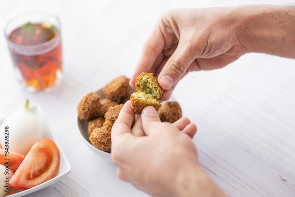 arab breakfast with hummus and falafel and fattah and foul on white wooden table Jordanian food arab breakfast with hummus and falafel and fattah and foul on white wooden table Jordanian food