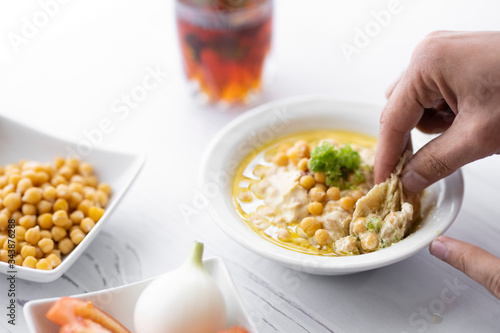Принти на полотні arab breakfast with hummus and falafel and fattah and foul on white wooden table