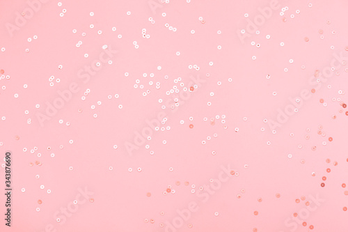 Pink confetti and stars and sparkles on pink background.