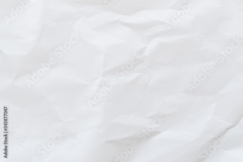Crumpled white paper texture background, top view