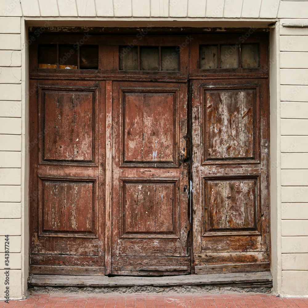 Old brown rustic timber door with paint coming off Old brown rustic timber door with paint coming off
