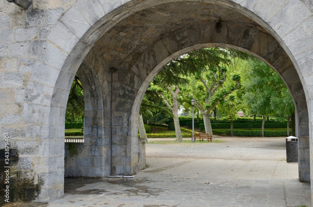Stone arch in garden in Pamplona, Spain
