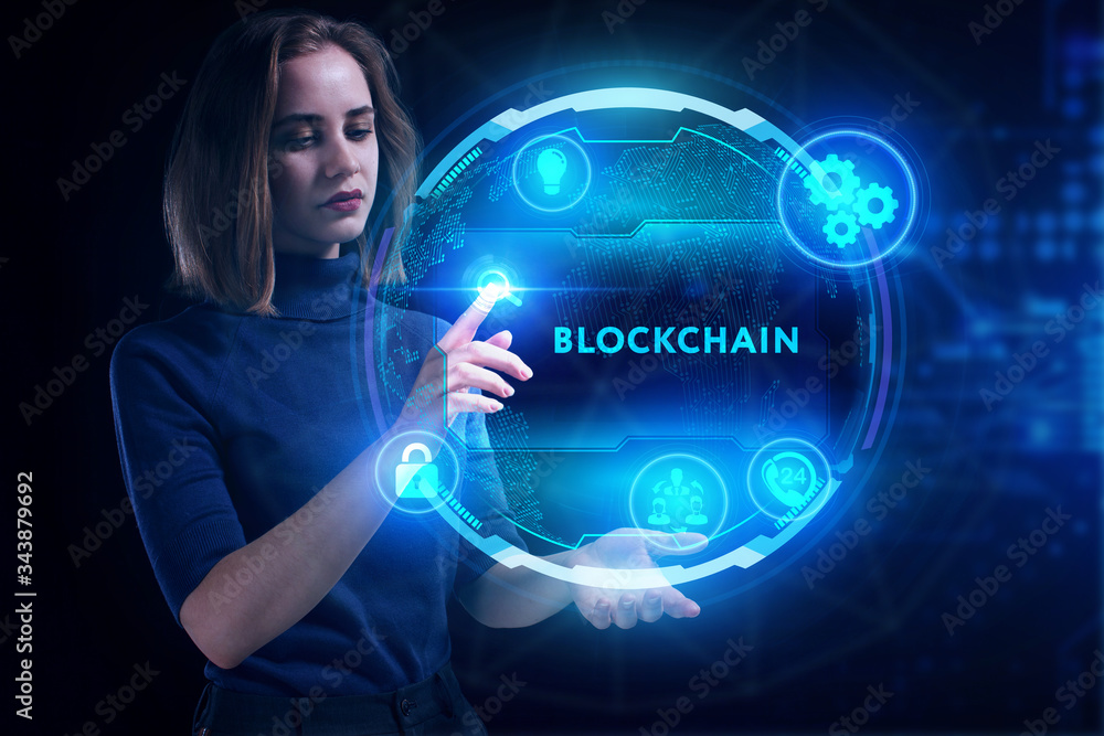 Business, Technology, Internet and network concept. Young businessman working on a virtual screen of the future and sees the inscription: Blockchain Business, Technology, Internet and network concept. Young businessman working on a virtual screen of the future and sees the inscription: Blockchain
