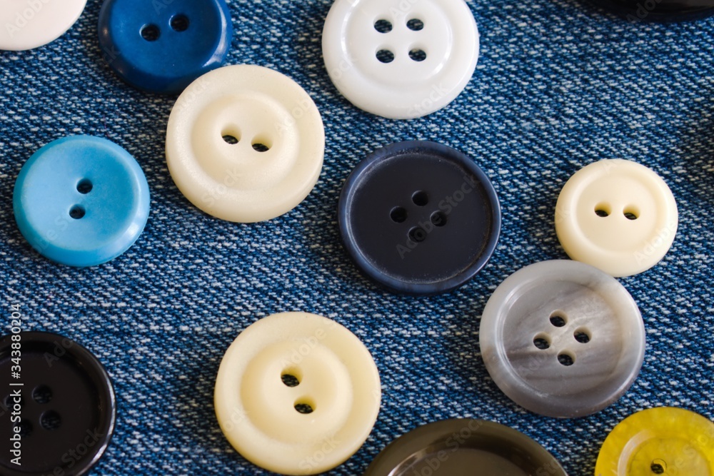 buttons in different colors on a denim caton buttons in different colors on a denim caton