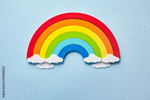 Vintage flat card with rainbow with white clouds on blue background. Chase the rainbow photo