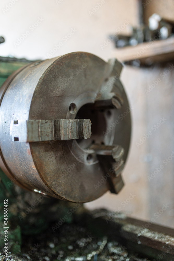 The old lathe machine is painted green.