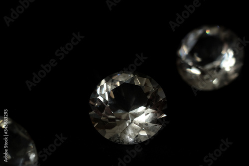 Diamonds, and colorful jewels in black and colorful background. Brilliant, expensive and precious crystal gemstone for jewelry. Closeup gem.