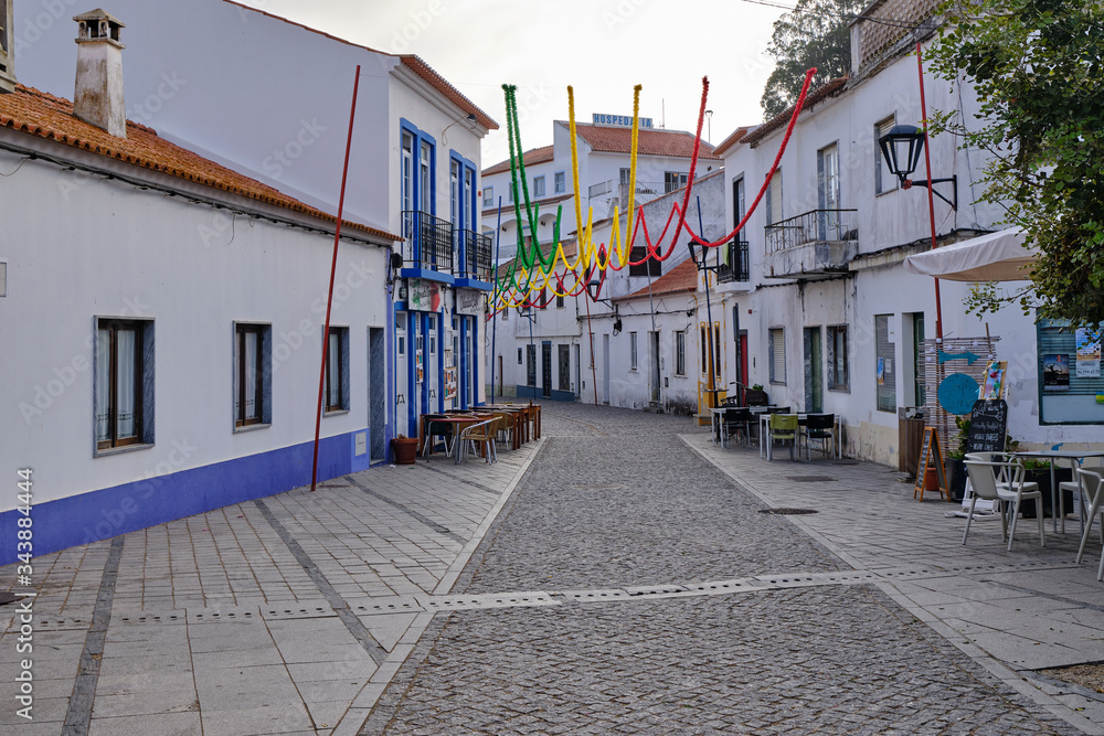 The village of Odeceixe decorated for the party. Solo Backpacker Trekking on the Rota Vicentina and Fishermen's Trail in Algarve, Portugal. Walking between cliff, ocean, nature and beach.