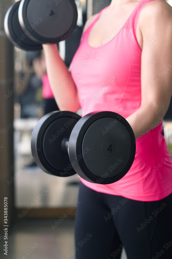 Thin thirties woman doing exercise in the gym Thin thirties woman doing exercise in the gym
