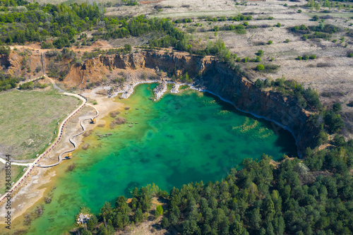 Fototapeta Naklejka Na Ścianę i Meble -  Aerial view of wooden path over turquiose lake colour. Drought. Drone top view.