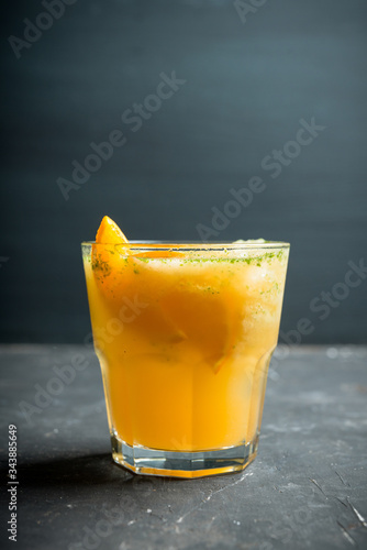 Old fashioned orange cocktail on rustic background. Selective focus. Shallow depth of field.
