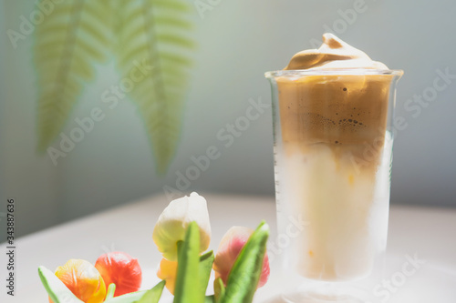 favorite and trend of summer drink from dalgona or frothy coffee with tulip decorate on white background