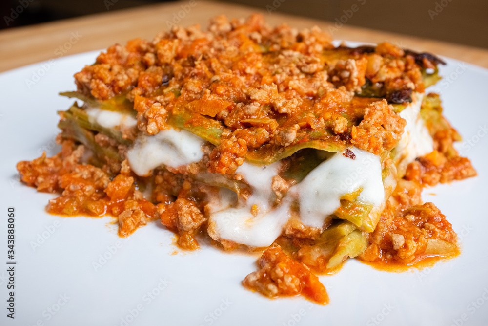 Close up of homemade Italian style green lasagna made with meat sauce and mozzarella cheese Close up of homemade Italian style green lasagna made with meat sauce and mozzarella cheese